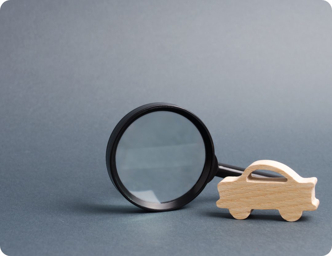 car figure and magnifying glass