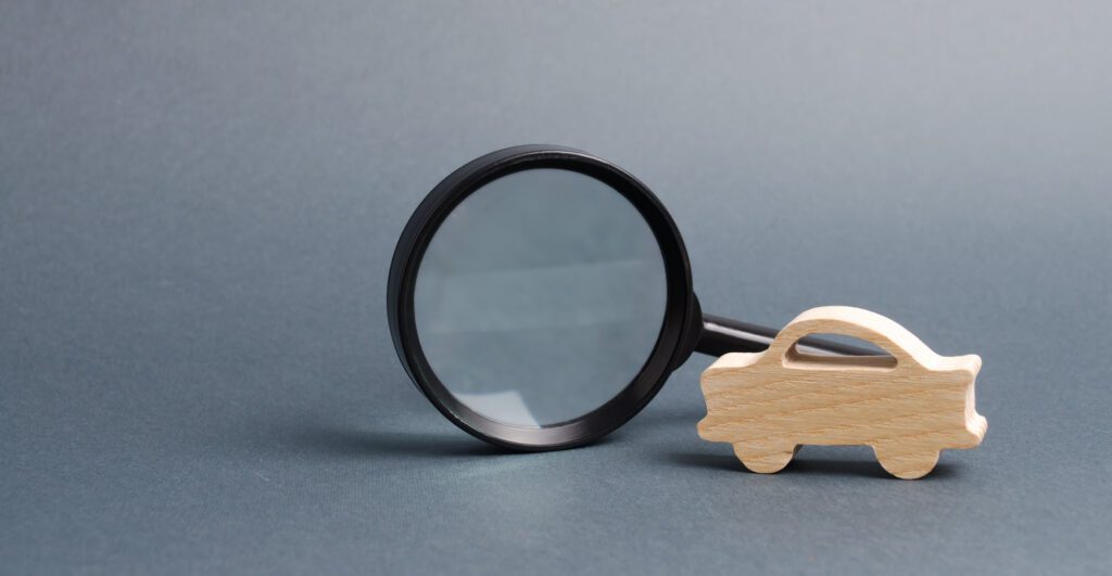 car figure and magnifying glass