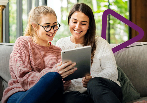 two friends looking at a tablet